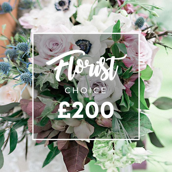 A stunning, high-end floral montage unfolds with a premium Florist Choice bouquet, presented in close focus and softened by a gentle, dreamlike background. The arrangement blends soft pastel tones with muted lilac hints in light pink garden roses, white anemones with their distinct dark centers, and subtly purple-grey roses that add contemporary sophistication. Blue eryngium thistles inject a crisp contrast, their geometric spikes offering modern texture against the bouquet's plush petals. Lush greenery fills the spaces between blooms, featuring eucalyptus-like leaves and rich burgundy or plum-toned foliage that adds depth and warmth. The composition exudes confident craftsmanship, suggesting a bespoke offering perfect for weddings, anniversaries, or a luxe home display, available for delivery across Gerrards Cross and nearby communities. A soft overlay notes the Florist Choice branding and price, anchoring the image as a designer package-the kind of arrangement a local florist in Gerrards Cross would curate for a memorable occasion. The overall effect is generous, natural, and elegant, inviting the senses to linger on scent, texture, and the quiet luxury of quality blooms.