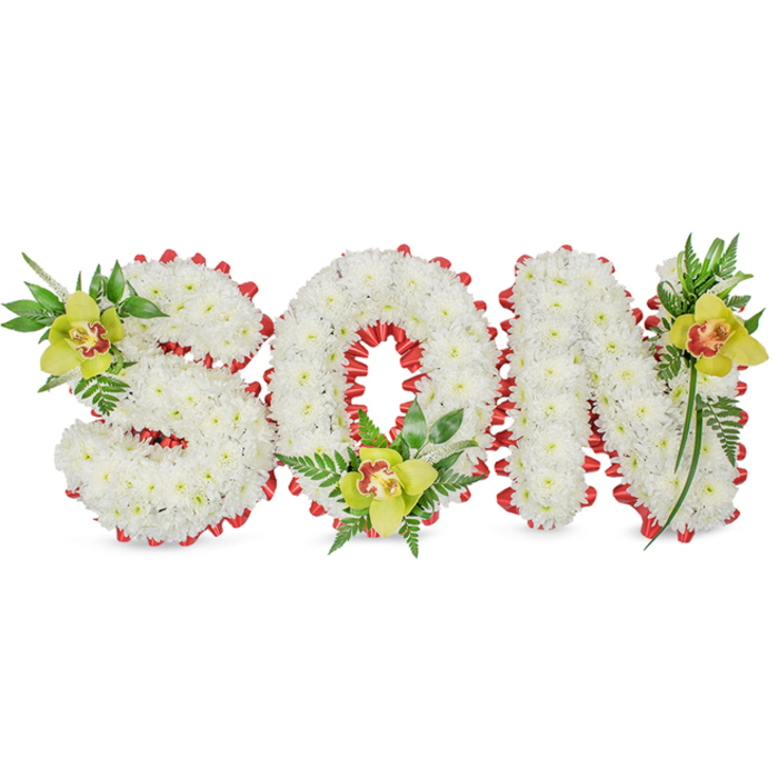 A carefully composed sympathy tribute presents the word 'SON' in bold, three-dimensional letters, each letter built from a sea of pure white chrysanthemum blooms whose tight petals create a soft, cloud-like texture and a uniform, respectful surface. A vivid red ribbon is woven and looped around the full perimeter and within the 'O', forming an elegant scalloped border that cuts a striking line across the white field and subtly evokes themes of love and courage. Anchoring each letter are three lime-green Cymbidium orchids-one tucked into the upper left sweep of the 'S', one cradled at the base of the 'O', and a final bloom placed near the upper right of the 'N'-their yellow-green petals and reddish-brown throats adding focal points of colour and organic shape. Around these orchids, fine fern fronds and longer glossy leaves extend upward and outward, creating a sense of natural movement and balance while adding dimensional depth to the letters. The piece sits against a clean white background beneath gentle, even lighting that reveals the contrast between the chrysanthemum's matte faces, the orchid's smooth texture, and the ribbon's sheen. There is a muted green scent from the foliage and the comforting, mild fragrance of the chrysanthemum that together underscore the arrangement's solemn intent. As a local florist experienced with the needs of families in Gerrards Cross and nearby Seer Green and Chalfont St Peter, I see this as a dignified option for memorial services, a handcrafted message of remembrance delivered with care to churches, chapels, or graveside services around the town.