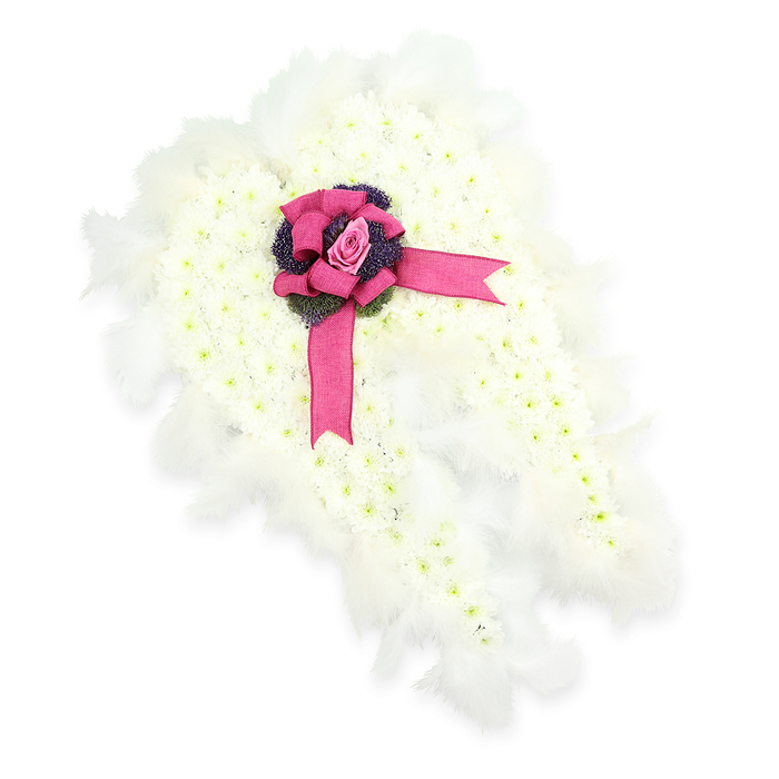 In this image, a striking sympathy tribute is styled as a pair of angel wings, laid out against a stark white backdrop that allows every petal and feather to stand out clearly. The wings themselves are formed from a dense blanket of tiny pure white flowers, likely spray chrysanthemums or similar blooms, packed tightly together so that the surface resembles a soft, untouched snowdrift. This gentle, cloud-like texture gives the arrangement a serene stillness, echoing the quiet lanes and calm corners around Gerrards Cross. Tracing the entire outer edge of the wings is a halo of soft white feathers, each plume light and airy, their feathery strands overlapping to create a sense of motion and softness, reinforcing the celestial, guardian-angel theme. At the central joining point of the two wings, an eye-catching bow made from rich fuchsia-pink satin ribbon is tied in generous loops, with its tails trailing downwards across the white floral surface. Nestled neatly into the heart of the bow is a single, finely shaped pink rosebud, its petals just beginning to unfurl, a delicate symbol of enduring love and gentle farewell. Beneath the rose, a cluster of dark purple or deep violet thistle-like flowers or textured foliage adds depth and contrast, introducing a touch of wild, natural beauty that sets off the surrounding white. The overall effect is one of quiet reverence and hope, a meaningful angel wing funeral arrangement that could be placed beside the coffin or near the front of a chapel service in Gerrards Cross as a tender expression of remembrance and peace.