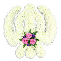 Set against a clean, uncluttered white background, this floral Khanda tribute appears almost to glow, its sacred Sikh symbol rendered entirely in fresh white chrysanthemums. The central double-edged sword rises straight and true, surrounded by the smooth circular form of the chakkar, while the two kirpans curve gracefully outwards, all defined by dense, tightly packed florets. Each chrysanthemum head is small and neat, with multiple fine petals that overlap to create a cushion-like surface, giving the whole piece a soft, cloud-like texture that conveys purity, respect, and serenity. At the very base of the design, nestled where the crossed kirpans meet, a contrasting cluster of colour draws the eye. Three full-bloom pink roses sit at the heart of this accent, their petals unfurling in gentle spirals, suggesting tenderness and love. Around them, deep purple blossoms - perhaps lisianthus or similar delicate flowers - tuck into the white background like small jewels, while sprigs of lush green fern and foliage frame the roses and provide a sense of natural movement. The arrangement feels calm and composed, much like a quiet walk along the tree-lined streets near Gerrards Cross station at dusk. Though the image is still, you can almost imagine the faint, fresh scent of chrysanthemum and rose, comforting and familiar at a time of loss. Created for Sikh funeral services, memorial gatherings, or private home remembrances in and around Gerrards Cross, this Khanda tribute offers a refined, heartfelt way to honour faith, heritage, and an enduring spiritual journey.