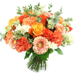 Bathed in clean, natural light against a brilliant white background, this hand-tied bouquet reads like an embrace of seasonal sunshine. At its heart are several large roses - some the color of polished copper, others a sunny marigold - their layered petals spiralling toward warm centers and releasing a soft, heady perfume. A generous halo of coral and apricot carnations creates a tactile, ruffled cushion around those roses, their dense petals inviting touch and lending abundant volume. Interspersed among the larger blooms are peach-toned gerbera daisies with flat, radiating faces and distinctive green-yellow eyes that catch the eye and lift the composition. Tiny white spray flowers, suggestive of freesia or small chrysanthemums, punctuate the warmer tones with bright highlights and a delicate floral counterpoint, while pale green, star-like clusters of filler (reminiscent of astrantia) add a feathered, woodland note. Silvery eucalyptus leaves with rounded shapes are threaded through the arrangement, offering a soothing, herbal fragrance and a modern, muted green contrast. The stems are neatly gathered and tied, the bouquet balanced to sit beautifully in a vase or to be handed over at the door. As a Gerrards Cross florist I imagine this arriving at a family celebration on Station Road or brightening a friend's kitchen after a visit to the local market; Flower Delivery Gerrards Cross would describe it as a joyful, handcrafted choice for birthdays, congratulations, or to say thank you with warmth and style.