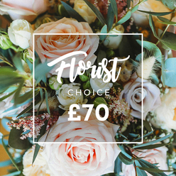 This overhead, intimate image presents a luxurious florist-picked bouquet that reads like a soft-bodied poem - pale blush roses unfurling like silk, creamy white blossoms forming pillowy pockets of light, and gentle peach tones warming the centre. Subtle notes of muted lavender or dusty mauve roses add a cool contrast while a haze of tiny pink florets and white filler flowers lends an airy, lace-like intricacy across the composition. Natural dried elements in cream and tan - think wispy grasses and textural seed heads - are tucked through the stems, introducing an earthy, nostalgic whisper that deepens the arrangement's visual story. Distinct, rounded eucalyptus leaves and other lush greenery weave through the flowers, their dusty blue-green tones providing structural rhythm and the suggestion of a fresh, botanical scent you might breathe in on a walk through nearby Burnham Beeches. Over the central flowers a crisp white rectangular frame overlays the image; inside, Florist Choice appears in an elegant script with CHOICE in a neat uppercase sans-serif directly beneath, and the price ?70 displayed in bold white numerals at the base of the frame. The soft focus and natural light heighten the romantic, sophisticated mood, making this bouquet feel ideal for Mother's Day, an anniversary or a quiet celebration. As someone who arranges for local homes around Gerrards Cross Common, I would recommend this as a thoughtful, tactile gift that invites touch, inhalation and lingering appreciation.