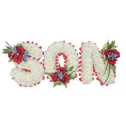 Arranged with quiet skill and heartfelt attention, this memorial spells SON in bold, three-dimensional letters made entirely of closely packed white chrysanthemums, their tiny blooms creating a cloud-like, tactile surface across each character. A bright red satin ribbon outlines each letter in a scalloped trim, the colour contrast sharpening the white mass and lending a stately silhouette. Three floral accents - positioned on the upper left of the S, the bottom centre of the O and the upper right of the N - introduce clusters of deep red roses, slender blue-purple spike flowers (likely liatris or similar), and lush dark green foliage including fern fronds and trailing leaves that cascade gently from each cluster. The arrangement is photographed on a neutral white background with soft daylight highlighting the roses' velvet petals and the satin's gentle sheen; the combined scent of roses and chrysanthemums is implied, warm and consoling. Intended as a personalised funeral tribute for a beloved son, this design balances purity and passionate remembrance; the white speaks of peace and the red of love and grief. As Flower Delivery Gerrards Cross, we prepare and deliver pieces like this with sensitivity to local needs - from family homes around Gerrards Cross station to nearby chapels and cemetery lodges - offering a refined, traditional tribute that honours memory with dignity.