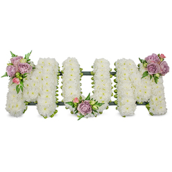 A lovingly handcrafted sympathy arrangement spells 'MUM' in strong capital letters, each letter densely cloaked in pristine white spray chrysanthemums that create a soft, textured surface like freshly fallen snow. The immaculate whites suggest purity and quietude under gentle, diffused light; the chrysanthemums' subtle green stems and compact petals lend a tactile, cushiony feel. Delicate accents of soft lavender roses and light pink rosebuds are placed in three refined clusters-one nestling on the upper left arm of the first 'M', another resting in the gentle hollow of the 'U', and the third crowning the upper right curve of the final 'M'-their velvety petals introducing warmth and a whispered fragrance. Slender fern fronds and fresh, pale-green foliage weave through the accents, offering contrast and a sense of living depth against the white. A dark green supporting frame, perhaps ribbon-wrapped or mossed, is visible beneath the blooms, providing subtle structure and a clean outline. This arrangement has been composed with the care of a local florist mindful of funeral etiquette, intended for chapel display, service tributes, or graveside dedication. Prepared by Flower Delivery Gerrards Cross, it reflects our neighbourhood sensibility-from the village high street to nearby Burnham Beeches-offering families a serene floral message of love, respect, and enduring remembrance for a mother or maternal figure.