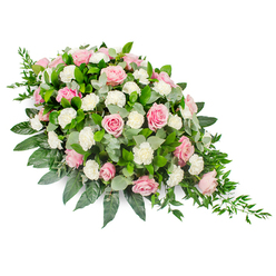 Set against a pure white background, this elongated teardrop funeral spray appears as a quiet river of pink and white blooms, flowing from a full, rounded top into a gentle point. The main flowers are pastel pink roses, some still cupped in bud, others fully open with spiralling, velvety petals that invite the eye to linger. Nestled between them are generous white carnations, their frilled edges creating a soft, cushion-like texture that contrasts with the smoothness of the roses. Deep green, glossy leaves provide a sturdy framework around the flowers, suggesting salal or camellia, while sprays of rounded, silvery eucalyptus leaves weave through the centre, adding depth and a cool, muted tone. From the slimmer end of the spray, fine ruscus stems and other trailing greens extend outward, giving the arrangement its distinctive cascading effect, like a tear traced in foliage. The composition is carefully balanced, with no harsh angles, just a continuous, soothing curve that feels especially fitting for moments of farewell. Imagined as a tribute for a Gerrards Cross family gathering at the church or cemetery, the design feels both traditional and personal, reflecting the gentle character of the town and its tree-lined streets. Every element looks meticulously placed by an experienced florist's hand, with ample blossoms so there are no gaps, only a lush, layered surface. The overall mood is one of serenity, respect, and enduring affection, making this spray an appropriate choice for resting on a casket, at the front of a chapel, or beside a framed photograph during a memorial service.