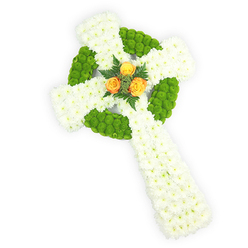 Viewed slightly from above on a stark white backdrop, this floral Celtic cross is an exercise in calm precision and heartfelt symbolism. The dominant field of small white spray chrysanthemums creates a plush, pillow-soft base that speaks of purity, stillness, and a gentle, tactile solace. Bright lime-green button chrysanthemums are worked into the design in intentional, almost architectural blocks - they trace the circular boss at the centre of the cross and alternate along the arms, giving the piece a rhythmic pattern and a tactile contrast between velvety petals and compact button heads. Nestled in the very heart are three warm orange-yellow roses, their open faces catching the light like a beacon; a few deep green fern fronds cradle them, adding depth and a whisper of woodland scent that would lift the arrangement's quiet mood. The soft studio lighting accentuates petal contours and the three-dimensional form, suggesting how this tribute might sit on a church lectern or beside a coffin at a local funeral in Gerrards Cross, or be delivered to a family home on the High Street after a memorial. As a florist with experience serving this community, I can see this design offered for those wishing to honour Celtic heritage - its palette gently recalling the green, white and gold of Irish memory - while remaining composed and reverent for mourners seeking a balanced, comforting tribute.