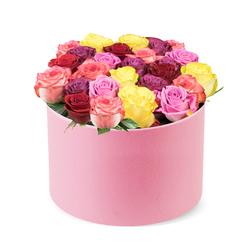 Imagine receiving this round pastel pink hat box, its velvet-soft skin cradling a domed garden of roses, delivered to a Gerrards Cross doorstep near The Broadway or the village green. The lid slides away to reveal dozens of blooms arranged with the florist's practiced care, each rose a little jewel. The colour story flows like a sunset: bright yellow petals glow beside ruby reds, magenta tones deepen, and pinks range from soft blush to vibrant bubblegum, with a handful of bi-colour blooms that blend pink and cream. The roses sit densely packed, petals overlapping in a lush tapestry that feels couture in hand and heart. Only a hint of green foliage peeks out, set deliberately to frame the bouquet and let the colour show at its fullest. The overall effect is contemporary yet timeless, a gift that signals celebration, affection, or heartfelt thanks.

This arrangement is a statement piece for anniversaries, birthdays, or simply to brighten someone's day. It suits a modern Gerrards Cross home, perched on a dining table, a console, or a window ledge where morning light can catch the soft pink box. The scent of rose and a whisper of citrus rises as you approach, inviting the senses before you even see every bloom in detail. For shoppers on the move in and around Gerrards Cross, this design is crafted for reliable freshness and generous longevity, with easy gifting and dependable seasonal stems. It's the sort of bouquet you'd expect from a skilled local florist, ready for timely delivery to make any moment feel special.