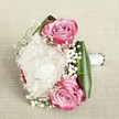 Imagine the gentle serenity of a spring morning in Gerrards Cross, reflected in this romantic bouquet: three striking pink roses, petals tinted and curled just so, cradle a pillow of lush, cloud-like white peonies. The peonies' layered petals seem almost weightless, as if gathering the soft air above the Chalfont St Peter parks nearby. Trails of dainty, pure white baby's breath weave through this floral tapestry, lending a whimsical, airy texture that dances between each blush and ivory petal. Vibrant green leaves-fresh and glossy as the hedgerows along Bulstrode Way-frame the arrangement, offering a graceful architectural border that heightens the illusion of the flowers floating above their textured fabric base. A hand-tied band of white satin ribbon completes the bouquet, the smoothness promising gentle control for any bride, bridesmaid, or recipient wishing to cherish the moment. Resting upon its light beige canvas, the bouquet radiates both structure and softness, evoking strong emotions: the hopefulness of beginnings, the tenderness of vows exchanged near Gerrards Cross's historic churches, and the subtle fragrance of blooms handcrafted by devoted local florists. Perfect for a wedding procession or as a heartfelt gesture, this composition is not merely a collection of flowers, but a celebration of love and artistry, thoughtfully gathered for delivery in Gerrards Cross.