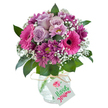 Bursting with joyful hues and inviting textures, this stunning bouquet from a Gerrards Cross florist effortlessly channels the area's refined charm. The rounded display features delicate lavender roses at its heart, their soft petals unfurling in a gentle embrace, surrounded by bold fuchsia Gerbera daisies whose bright pink faces radiate positivity. Rich, dark magenta and plum chrysanthemums contribute layers of texture and depth, blended harmoniously with airy clouds of baby's breath that catch the light and lift the spirits. Glossy dark greens curve around the base, echoing the fresh greenery found throughout the village parks and gardens. The flowers rest gracefully in a clear glass vase marked with a unique crackled texture, a tactile nod to artisanal craftsmanship, and are finished with a simple raffia knot and crisp white gift tag. Perfect for celebrating birthdays, marking new beginnings, or as a heartfelt thank you, this bouquet offers the promise of fresh, local flowers-crafted and delivered with care across Gerrards Cross, blending sophisticated design with the genuine warmth of a neighborhood florist.