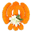 A meticulously crafted floral Khanda rests against a clean white backdrop, its sacred form rendered entirely from hundreds of tightly packed, bright orange marigold blossoms. The warm, velvety marigolds build every curve and edge of the emblem-the circular chakkar, the two crossed kirpans and the upright double-edged khanda-creating a plush, almost sculpted surface that catches soft studio light and casts a subtle drop shadow beneath, suggesting a freestanding ceremonial piece. At the very centre of the symbol, where the swords converge, a small yet striking cluster of pristine white lilies offers a calm counterpoint: at least two fully open lilies with gently unfurling petals, pale yellow-green stamens, and a delicate perfume implied by their poised form, surrounded by smaller white buds just beginning to reveal themselves. Shiny, deep-green foliage and light sprays of baby's breath (gypsophila) are woven among the blooms, their cool tones lifting the intense orange and adding depth, texture and a feeling of reverent balance. The overall effect is both celebratory and contemplative-suitable for Vaisakhi, Gurpurab or a respectful memorial-invoking devotion through colour and craft. As a local florist's offering to a community observance in and around Gerrards Cross and nearby Beaconsfield, this floral Khanda reads as an intimate, tactile tribute: bright, textured marigolds for tradition, calm white lilies for purity, and greenery to root the symbol in quiet dignity.