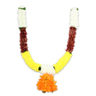A lovingly crafted, U-shaped ceremonial garland captured against a clean white studio backdrop, its form and colours evoking warm festival light. As a florist who often assembles torans for local homes around Gerrards Cross High Street, I recognise the deliberate rhythm of its segments: short vertical crowns of creamy-white, chrysanthemum-like pom-poms sit at the very top of each arm, their soft, cloud-like texture seeming almost to filter the light. Directly beneath those pale clusters are bands of deep reddish-brown, a dense, textured interval that reads like layered dried petals or mahogany-toned fabric, grounding the garland with a warm, earthy note. The curved arms then open into generous swathes of bright golden-yellow, densely packed and frilly, unmistakably reminiscent of marigolds (genda phool) used for puja and festive doorways. Tiny hints of bright green-leafy accents or stitched ribbon-appear where the colour blocks meet, giving the composition gentle punctuation. At the lowest central point a lavish pendant hangs: a full, multi-layered cluster of vivid orange ruffled petals that forms the visual heart of the design, playful and auspicious. Under soft studio lighting the synthetic fibres pick up a subtle sheen, suggesting silkiness to the touch while promising the durability of an artificial piece suited to repeated use during Diwali, Ganesh Chaturthi, weddings, or as a welcome toran for a Gerrards Cross front door. The overall impression is ceremonial yet homely; its textures invite imagined scent-warm, earthy, a memory of marigolds-while its compact construction speaks of careful hand-assembly by a florist who appreciates both tradition and everyday practicality.
