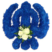A striking Sikh Khanda floral arrangement dominates the image, its iconic outline sharply defined against an immaculate white background. The entire symbol - the upright central sword, the enclosing circular chakkar, and the two symmetrical side kirpans - is crafted from a tight mass of royal blue chrysanthemums or similar small-headed blooms. Each flower is nestled closely against the next, producing a thick, textured surface with an almost quilted feel, the blue so deep and even that it evokes a sense of calm strength. At the lower portion of the central sword, a contrasting cluster of white and green flowers has been tastefully integrated into the design. Three white roses, lush and full with their layered petals gently unfurling, form the heart of this accent. Around them, sprigs of delicate white filler flowers, likely gypsophila, bring an airy lightness, while a ring of rich green foliage provides a natural frame and softens the transition back into the surrounding blue. The lighting is soft and diffuse, so the petals appear velvety and the greens look freshly cut, as though they have just been prepared for a service in a local Gerrards Cross venue. Subtle shadows outline the curves and edges of the Khanda, giving the tribute a dimensional, almost floating quality. Intended for Sikh funerals, remembrance services, or commemorative gatherings across Gerrards Cross and nearby Denham and Chalfont St Peter, this floral Khanda carries a quiet message of faith, loyalty, and peace, allowing families to express their love and respect through a symbol that feels both personal and deeply rooted in Sikh tradition.