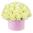 An elegant hat box filled with an abundant dome of cream and pale ivory roses sits centered against a pure white background, radiating a quiet, luxurious charm. The round pastel pink box, with its smooth, matte surface, cradles dozens of meticulously arranged roses whose velvety petals open in soft spirals, each bloom revealing a gentle transition from creamy outer petals to a whisper of pastel yellow deep at the centre. Packed closely together, the roses form a seamless, overflowing canopy, with just a few delicate touches of green foliage barely visible beneath the dense cluster, adding a subtle hint of natural contrast. The lighting is bright yet soft, emphasizing the intricate textures of the petals and the harmonious blend of shades without overpowering the composition. The overall effect is one of polished sophistication and heartfelt romance, reminiscent of a refined anniversary surprise delivered to a townhouse near Dukes Wood or a stylish home off Orchehill Avenue in Gerrards Cross. This image reflects the modern appeal of hat box arrangements while celebrating the timeless symbolism of pale roses-purity, devotion, and enduring affection. It is easy to imagine this piece gracing a dinner table for an intimate celebration, sitting on a console table in a light-filled Gerrards Cross sitting room, or being received as a thoughtful, luxurious gift to mark a special milestone for someone deeply cherished.