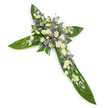 A solemn, elegant floral cross photographed on a stark white background from a slight overhead angle, its clean presentation emphasising every texture and tone. The structural arms of the cross are formed from broad, glossy tropical leaves-think Ti leaves-with deep green, waxy surfaces and visible veins providing a verdant, protective foundation. At the intersection and tracing each arm sits a concentrated carpet of soft white and creamy ivory blooms: ruffled lisianthus with their layered petals and tight buds, alongside small rounded chrysanthemum-like flowers that brighten the composition with quiet radiance. Interspersed among the pale flowers are sprays of tiny lavender-purple star-shaped accents-delicate limonium or small asters-that give a whisper of cool, calming colour and gentle depth. Fine green filler foliage peeks through the clusters, softening edges and adding a natural, meadow-like texture against the smooth leaves. The lighting is even and gentle, lending a soft shadow that suggests a modest overhead light, the whole arrangement reading as dignified and peaceful. A faint, green-tinged fragrance seems almost perceptible from the description: the vegetal freshness of leaves and the cool, powdery scent of lisianthus and asters. This cross reads as a respectful sympathy tribute, suitable for funeral services, memorial gatherings, or church altars in Gerrards Cross and the surrounding villages. It is the kind of arrangement a local florist would place with care at a graveside or church ceremony, offering a visual quietness that speaks of reverence, consolation, and enduring remembrance.