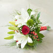 Set against a neutral, finely woven linen-like background, this hand-crafted bouquet appears as though a local Gerrards Cross florist has just laid it down on a table by a sunlit window. The dominant impression is one of graceful contrast, led by several large white oriental lilies whose trumpet-shaped blooms flare outward with effortless elegance. Some lilies are fully unfurled, revealing their smooth, gently undulating petals marked by faint russet speckles at the throats, while others remain in fresh, green bud form, promising a second wave of beauty for the days ahead. At the centre, a single deep red rose anchors the design, its velvety petals wrapped in a tight spiral that draws the eye inward and conveys an immediate sense of romance, ideal for a wedding morning in Gerrards Cross or a quiet anniversary supper at home. Nestled alongside, two rounded tufts of green trick dianthus add a delightfully tactile, moss-like texture, giving the bouquet a modern twist without disturbing its classic mood. Fine sprays of baby's breath weave delicately between the larger stems like a light, floral mist, while glistening red hypericum berries punctuate the greenery, mirroring the rose's hue and hinting at seasonal celebrations. A generous collar of assorted foliage-broad glossy leaves, slender blades of grass-like greenery, and soft arching stems-builds volume and movement, drawing the gaze along the diagonal line of the composition. At the base, a wide red satin ribbon wraps tightly around the stems, its sheen catching the light and adding a polished finishing touch. The bouquet feels refined yet warm, perfectly suited for wedding photography, registry office ceremonies nearby, or romantic same-day flower delivery across Gerrards Cross and the surrounding villages.
