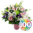Displayed against a spotless white background, this joyful centenary arrangement looks like it has just been prepared by a local Gerrards Cross florist for a much-loved elder's 100th celebration. On the left, a stylish ribbed vase in soft matte pink grounds the scene, its gentle tone allowing the bouquet's colours to sing. From it bursts a luxuriant composition of fresh flowers in harmonising shades of light pink, mauve, purple, lavender, lime green, and white. Tall, elegant Oriental lilies in pale blush rise above the main body of the bouquet; some blooms are fully open, star-shaped and poised, while others remain in elongated buds, hinting at future blossoms. Around them, soft pink and dusty rose-coloured roses cluster closely, their many-petalled heads unfurling like delicate silk. Deep purple lisianthus blooms are threaded throughout, bringing depth and a slightly woodland feel, while tiny lavender asters with sunny yellow centres punctuate the design with dainty colour. Bright lime green button chrysanthemums add playful spherical texture, standing out vividly against the softer pastels. Fine sprays of white baby's breath drift between stems like a light mist, giving the arrangement a romantic, airy softness that would sit beautifully on a table in a home near West Common or along a quiet Gerrards Cross lane. Supporting it all is an abundance of glossy dark green foliage, giving structure and contrast. To the lower right, a celebratory round foil balloon overlaps the bouquet's base. Its surface is filled with rainbow confetti dots in red, orange, yellow, green, blue, and purple, and at the centre, the large white numbers 100 appear slightly raised, unmistakably announcing a century reached. The overall impression is one of joyful pride, longevity, and heartfelt family celebration.