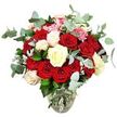 A dramatically full bouquet of roses sits in a clear glass vase, silhouetted against a clean white background so that every colour and curve is easily imagined, as if it has just been set down in a Gerrards Cross living room after a surprise delivery. The arrangement is packed with two dozen or more roses in sumptuous deep red and glowing scarlet, their velvety petals unfurling in layers that suggest warmth, devotion, and long-lasting romance. Some flowers are fully open, displaying generous, swirling centres, while others hold tighter, bud-like forms that add depth and variety. Nestled among the red roses are creamy white and soft ivory blooms, a few brushed with the faintest hint of pale pink on the outer petals, softening the palette and bringing a sense of balance and light. Tiny, bright pink accent flowers reminiscent of mini carnations peek between the larger rose heads, lending fine texture and a cheerful spark of colour. Surrounding and threading through the blooms are rounded stems of blue-green eucalyptus, their silvery cast and distinctive shape creating a fresh, modern framework that echoes the greenery seen in nearby Gerrards Cross gardens. Deeper green foliage and subtle silvery-green leaves fill in the base and sides, ensuring the bouquet appears lush and complete from every angle. All stems gather neatly into a clear glass vase with a rounded base narrowing to a slimmer neck, where the clean water level is visible and underscores the freshly-cut feel. With the plain white background providing a gallery-like setting, the bouquet's richness, texture, and romantic mood become the sole focus, perfectly suited to celebrating anniversaries, special dates, or heartfelt love notes shared in homes around East and West Common.