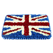 A carefully crafted Union Jack floral tribute fills the frame, its rectangular shape and clean lines giving it a formal, ceremonial presence. The base is a dense, uniform layer of dark blue chrysanthemums, each bloom pressed closely to the next so that the background appears almost like a softly textured carpet of colour. On top of this, crisp white flowers form the bold vertical and horizontal bars of St George's Cross, their luminous petals standing out clearly against the blue and lending the piece a calm, composed symmetry. Cutting diagonally across, vivid red blossoms outline St Patrick's Cross, edged with fine white bands to keep the familiar flag design sharp and accurate. The red flowers are plump and velvety, evoking warmth, courage, and devotion, while the white blossoms bring purity and peace to the composition. The entire tribute has a lightly domed profile, giving it a sculpted, three-dimensional look that catches gentle highlights along the top of each flower head. At the lower edge, a pleated blue satin-effect ribbon provides a tidy, elegant border, mirroring the flag's tones and framing the arrangement like a piece of ceremonial regalia. The overall mood is one of solemn Pride and heartfelt remembrance, the kind of Union Jack coffin tribute families in Gerrards Cross might choose for a veteran, a public servant, or a loved one with strong patriotic ties. It feels designed to sit in quiet dignity at a funeral service, memorial gathering, or graveside ceremony, offering a final, visually powerful expression of respect and national identity.