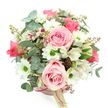 This image shows a beautifully composed hatbox flower arrangement set against a pure white background, photographed from a slightly overhead angle so the viewer can look right down into the heart of the bouquet. The container is a smooth, round hatbox in a soft blush pink, encircled by a narrow, deeper pink satin ribbon with a small cream tag resting to one side, hinting at a quality local florist's touch in Gerrards Cross. Rising from the box is a full, rounded bouquet in gentle tones of pink, white, and green, evoking calm romance and quiet joy. Large, pale pink roses with velvety petals are the main feature, their blooms at varying stages of openness so the arrangement feels alive and freshly made. Around and between them, crisp white chrysanthemum daisies with vibrant green centres add clarity and light, while white alstroemerias, dusted with fine purplish-red streaks and speckles, bring intricate detail and a hint of sophistication. The foliage is rich yet soft: rounded eucalyptus leaves in silvery green cascade slightly over the edge and weave through the flowers, suggesting coolness and a modern, airy style, while darker, slender leaves provide contrast and a more traditional garden feel. Small tufts of reddish-brown buds or berry-like sprigs nestle discreetly among the petals, grounding the pastel colours with a warm, natural accent. The result is an arrangement that feels perfectly suited to marking a birthday, anniversary, or heartfelt thinking of you gesture, ready for thoughtful delivery to homes and offices across Gerrards Cross.