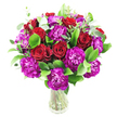 A lush, rounded bouquet of deep crimson roses and magenta-purple carnations sits in a clear glass vase against a clean white background, the arrangement feeling both celebratory and intimate. The roses range from tightly furled buds to gently opening blooms, their velvety, spiralled petals catching soft light and suggesting a classic, romantic scent; tucked between them are abundant carnations, their ruffled edges and saturated, almost fuchsia tones offering lively texture and an energetic counterpoint to the roses. Glossy, bright green foliage-reminiscent of ruscus-forms a verdant cradle that amplifies the jewel-like reds and purples, while slender sprigs of silvery-green eucalyptus lift the composition with modern lightness and a cool, herbaceous aroma that would be noticeable even at a short distance. The stems are visible through the transparent vase, lending the display a fresh, clean honesty and a sense of simple elegance. Composed into a full, dense cluster, the bouquet feels intentionally abundant, the blooms arranged to create a soft dome that reads well from any angle. Against the white backdrop the colours appear saturated and luminous, the deep red and vivid purple popping with clarity-an effect that photographs and in-person deliveries both benefit from. As a florist who knows Gerrards Cross and its rhythms-the convenience of the High Street and the quiet mornings near the station-I imagine this piece arriving to mark an anniversary, a heartfelt congratulations, or to brighten a dining table before an evening gathering. It communicates warmth, thoughtful craftsmanship, and the kind of freshness you expect from local floral work in Gerrards Cross and nearby Chalfont St Peter.