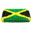 A bold, rectangular floral display captures the essence of the Jamaican flag using only fresh flowers, arranged with the precision of a tapestry. The eye is immediately drawn to the vivid yellow saltire, where tightly bunched golden blooms form a clean, diagonal X from corner to corner, their petals layered like tiny rays of sunlight. Nestled between these crossing lines, the top and bottom triangles are filled with lush green flowers, densely massed so they resemble a soft, living carpet, each ruffled head catching light and shadow. Flanking the design, the left and right triangles are crafted from deep black or very dark petals, placed so close together that they create an almost velour-like surface, adding seriousness and depth. The arrangement has a sturdy, three-dimensional profile, like a thick floral panel that could be placed lovingly beside a coffin or at the front of a service in Gerrards Cross, perhaps in one of the town's quiet churches or crematorium chapels. Set against a bright white background with even lighting, every contour of the petals and every subtle shift in tone are clearly visible, highlighting the skill and patience behind the tribute. The design speaks strongly of Jamaican identity, resilience, and pride, yet it carries a gentle softness appropriate for a funeral or memorial. It feels like a heartfelt message expressed in flowers - a final gesture of respect and love for someone whose roots and culture meant everything to them.