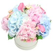 This bouquet is pure poetry in pastels, a harmonious symphony of delicate and lush textures that glows softly under gentle light. Billowy blue hydrangeas nestle alongside frilled pink peonies, their petals whispering of spring with every nuanced layer. Wisps of pale roses and a scattering of blush calla lilies add an elegant flourish, drawing your eye in with their sculptural grace. The arrangement sits lovingly in a round white hat box, which feels contemporary and clean, letting the blooms themselves sing. There's a sweet, almost nostalgic fragrance that rises from the peonies, blending seamlessly into the cool freshness of hydrangea. This bouquet could be a heartfelt gesture of congratulations or comfort-a gentle reminder that beauty and kindness can exist in the simplest of moments. As a local florist, I feel privileged to craft pieces like this, where every petal and hue feels cared for and thoughtfully placed. This bouquet is designed for Gerrards Cross deliveries, bringing a quiet celebration to homes near Beaconsfield, Denham, and Chalfont St Peter. Available for same-day delivery across the area, it carries a soft elegance that suits birthdays, new babies, or a moment of serenity in a busy week. Flower Delivery Gerrards Cross is proud to bring this pastel poem to life, hand-assembled with careful attention to fragrance balance, color harmony, and the way light catches the satin sheen on a peony's surface.