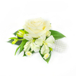 Set against a clean, brilliant white backdrop, this refined boutonniere or petite corsage reads as a study in bridal purity and quiet formality. At its heart sits a large, creamy white rose whose many velvety petals are tightly layered in the centre and unfurl outward into a soft, voluminous cup - the petals catch gentle studio light, throwing delicate shadows that give the bloom depth and a tactile plushness you can almost feel. Below and around the rose a cluster of narrow, pale freesia blossoms opens with graceful, trumpet-like forms while a pair of elongated, yellowish-green freesia buds to the left hint at promise and gradual unfolding. Tiny, daisy-like white florets with tiny yellow centres nestle beneath, their small faces and feathery stems offering a quaint, country-charm contrast to the rose's formal elegance. Deep, glossy green leaves - narrow and structured - cradle the blooms and provide a crisp, vivid backdrop that makes the whites sing. On the right, a small cluster of lustrous white pearls is gently tucked into the foliage, lending a soft, classical shimmer that evokes vintage bridal jewellery and quiet sophistication. The overall composition is compact and wearable, balanced for a groom's lapel or a mother-of-the-bride's wrist, and the cool, faint scent of freesia and rose is implied in the description. This piece would be at home on the Gerrards Cross High Street wedding circuit or paired with formal attire for special occasions around the station and The Green, offering a modest, timeless elegance for ceremonies and celebrations in the local area.