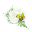 A quiet, refined corsage arranged on a crisp white backdrop: a single white Phalaenopsis orchid sits at the heart, its broad, satiny petals unfurling with a gentle, wax-like sheen that catches the soft studio light. The orchid's throat shows a subtle warmth-hints of pale yellow and gold with faint brown veining-giving the pristine white bloom a quiet depth. Around it, delicate sprays of asparagus fern fan out in feathered strokes, their pale green fronds lending an airy, almost tulle-like texture that contrasts the orchid's smooth surface. To the right, clustered reddish-pink hypericum berries add a small, jewel-like pop of colour and a touch of rustic charm; beside them a compact, lime-green chrysanthemum or similar filler peeks through, its tiny petals and textured mass offering a bright, verdant counterpoint. The composition is deliberately compact yet asymmetrical, moving outward on the left and down to the right so it reads beautifully when pinned to a lapel or worn as a wrist corsage. The white background keeps every contour and shadow crisp, making the petals, berry gloss, and fern filigree easy to distinguish even at a glance. As a florist working in Gerrards Cross, I picture this piece paired with a summer wedding along the village green or carried to a reception near the High Street-an understated, tactile accent that smells faintly of green freshness and feels feather-soft to the touch. It's an elegant, wearable study in contrast: cool white, warm throat tones, and lively green accents, designed to read clearly for anyone relying on descriptive detail to imagine the arrangement.