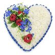 A generously sized, heart-shaped sympathy tribute is shown in a clear overhead view, set against a neutral light background so that every detail of the floral work stands out. The heart is completely covered with tightly massed white chrysanthemums, their tiny petals creating a smooth, plush surface with a gentle, natural variation that gives the heart depth and softness. Around the very edge, a royal blue satin ribbon has been painstakingly pleated and ruffled, forming a continuous, decorative border that catches the light and lends the design a formal, almost regal air, the type of tribute often requested for meaningful farewells in Gerrards Cross churches and local crematoria. On the upper left curve, a dramatic spray of flowers is arranged on top of the chrysanthemum base: three deep red roses, fully open and rich in colour, are nestled among dark, glossy leaves. From this focal point, electric blue dendrobium orchids spill downwards, their slim stems bearing star-like blooms whose petals shift between blue, indigo, and a touch of teal. Interwoven with the orchids are fine green tendrils that curl and loop, adding softness and a sense of movement. On the opposite side, along the lower right edge of the heart, a single red rose stands in quiet contrast against the white mums, echoing the main cluster and drawing the eye gently around the shape. The combination of white, red, and vivid blue creates a powerful visual expression of purity, devotion, and calm, making this heart-shaped arrangement a touching floral tribute for funerals, wakes, or memorials held in the Gerrards Cross area.