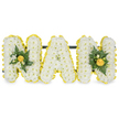 A tender, three-dimensional sympathy tribute carefully shaped to spell the name NAN in bold capital letters, floating against a clean white background. Each letter is densely packed with hundreds of small, pristine white chrysanthemum florets that create a soft, cloud-like surface and a reassuring, tactile fullness when seen up close. Around the edge of every letter a vivid ring of bright yellow button chrysanthemums, or similarly small yellow blooms, has been placed to trace each contour with cheerful definition, giving the composition a warm, sunny outline that lifts the otherwise serene white. The two outer N letters carry a low, central cluster of glossy deep green foliage-suggestive of camellia or ruscus leaves-balanced with a few sprigs of delicate fern for texture, and highlighted by tighter yellow flowerbuds tucked into the greens to add depth and a gentle focal point. The central A is intentionally unadorned, its pure white face framed only by the yellow border so the simplicity of the letter reads clearly in the calm studio light. A discreet dark green support bar runs behind the upper sections of the letters, making the piece suitable for standing against a chapel wall or for laying to rest at a graveside. The overall scent is faint and fresh, the chrysanthemums lending a clean, classic floral note, while the yellow blooms bring a soft summer sweetness. As a Gerrards Cross florist would prepare for a funeral at a nearby church or a quiet service near Burnham Beeches, this arrangement combines dignity with a hopeful touch of colour to honour a beloved Nan with respectful warmth and clear, heartfelt lettering.