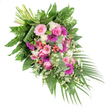 Set against a crisp white backdrop, this lush diagonal funeral spray appears as though it might be placed along a casket or beside the lectern in a quiet Gerrards Cross church. The design flows from the upper left to the lower right, its full, cascading form rich with colour and texture. At its heart are several prominent gerbera daisies in soft pastel pink, vivid fuchsia, and deep magenta, their open, daisy-like faces bringing both brightness and tenderness. Around them, elegant pink roses with neatly spiralled petals nestle closely, offering a timeless symbol of love and gratitude. Clusters of ruffled white blooms-resembling small carnations or chrysanthemums-are scattered throughout, creating a soft visual cushion. Tiny white daisy-style filler flowers weave gently between the larger blossoms, adding an airy, whimsical touch that suggests wildflowers along the paths out towards Denham. Bright red hypericum berries are tucked here and there, giving small bursts of colour and a tactile, berry-like texture. The foliage is abundant and varied: broad, glossy deep-green leaves form the main structure, feathery ferns soften the outline, and rounded, silvery eucalyptus leaves add both visual freshness and a hint of cool, herbal fragrance. From the lower right corner, long, slender palm fronds extend outward, enhancing the sense of sweep and movement. At the upper left, neatly bundled stems are visible, a quiet sign of the florist's care and skill. Designed as a respectful condolence tribute, suitable for delivery to local funeral homes and services across Gerrards Cross, this arrangement speaks gently of remembrance, comfort, and enduring love.