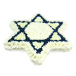 A carefully constructed Star of David funeral arrangement dominates the scene, its strong, symbolic outline formed entirely from fresh, small-headed chrysanthemums. Set against a seamless white background, the star's silhouette appears exceptionally clear: a wide border of pure white flowers wraps around all six points, while the central hexagon and small connecting segments are also filled with the same pristine white, giving a sense of softness and peace. In contrast, the inner framework of the two interlocking triangles is rendered in deep navy-blue blooms, their rich tone crisply marking out the familiar Magen David geometry that is central to Jewish faith and identity. Each flower is tightly packed, creating an even, plush texture with no visible gaps, giving the tribute a professional finish that speaks of experience and care, like something prepared by a seasoned florist for a service in Gerrards Cross or a nearby community such as Denham. The lighting is soft and diffused, with minimal shadow, allowing the white to remain clean and bright while the blue stays velvety and saturated. The overall atmosphere conveyed is one of quiet dignity and solemn remembrance, suitable for a Jewish funeral, unveiling, or memorial gathering. This arrangement not only honours the deceased but also gently acknowledges the traditions, prayers, and memories shared by family and friends, much as a thoughtfully chosen floral star might do when delivered to a local synagogue or funeral home serving the Gerrards Cross Jewish community.