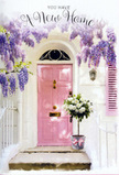 This inviting doorstep scene in Gerrards Cross looks like the perfect welcome after signing papers in town and wandering home along Packhorse Road with a heart full of anticipation. A gently glowing pink front door forms the centre of the picture, painted in a soft pastel blush that stands out against creamy whitewashed walls. Above, wisteria drapes in generous clusters of lavender and lilac, its blossoms trailing like fragrant ribbons over the entrance. The vine's twisted stems and drooping blooms create a natural canopy that softens the architecture, and you can almost imagine the light, powdery scent drifting on a mild Buckinghamshire breeze. To the side, a single shutter is painted in muted tones that echo the door, bringing a sense of harmony and care to the frontage, as if every detail has been thoughtfully considered. At the base of the door, placed carefully on the stone step, sits a tasteful grey metal bucket overflowing with white and cream roses. Their plush, layered petals are dotted with fresh soft-green foliage, giving the impression they've just been arranged by an expert florist after an early market run. A tender pink ribbon wraps around the bucket, tied in a neat bow whose ends rest lightly on the step, adding a final romantic touch. Soft sunlight pools around the entrance, highlighting the curves of each petal and casting gentle shadows that suggest late afternoon. The mood is tranquil yet full of possibility-a floral embrace that turns an ordinary Gerrards Cross doorway into a symbol of housewarming joy, ready to greet family, friends, and every new memory that will cross this threshold.