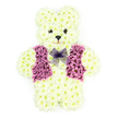 A soft, comforting floral teddy bear memorial is displayed here, created with the care and detail of a cherished keepsake. The entire teddy silhouette - from round ears and gentle cheeks to the plump tummy and tucked-in legs - is covered in layers of creamy white chrysanthemums, giving the impression of thick, cuddly fur. Each tiny flower is placed with precision, so the surface appears smooth yet richly textured, with subtle variations in cream and ivory tones that bring depth and warmth to the design. The bear's face is simple but expressive: two dark floral centers sit where the eyes would be, bright against the pale petals, while a smaller, rounded dark bloom marks the nose, suggesting a sweet, almost storybook expression that feels both innocent and calm. Draped across the front of the teddy is a carefully constructed floral vest, made from velvety petals in shades of purple, lilac, and mauve, arranged to resemble a tailored garment with clear lapels and a gentle V-shaped opening. The colour contrast between the vest and the pale fur-like flowers adds a sense of personality and tenderness, as if the teddy were dressed specially for an important goodbye. At the neck, a delicate lavender mesh bow is tied neatly, its gossamer texture softening the overall look and adding a whisper of elegance. This floral sculpture would be chosen as a unique funeral tribute in Gerrards Cross, perhaps delivered to a local chapel or family home, offering solace and quiet remembrance. It captures the essence of childhood comfort and the enduring love families here feel when saying farewell.